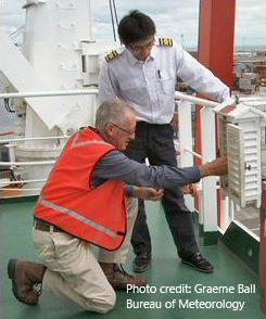 an image of a man looking at some on screen weather map in a ship
